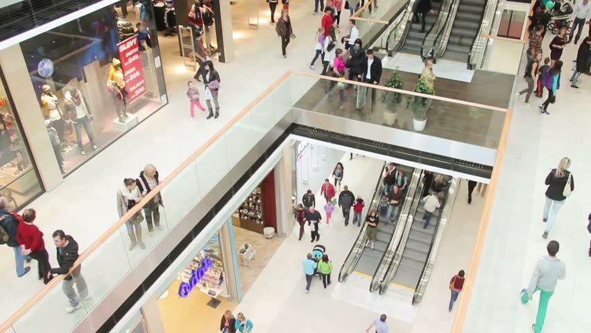 Slightly defocused crowd of walking people in the newly opened shopping mall