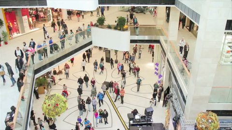 Slightly defocused crowd of walking people in the newly opened shopping mall center