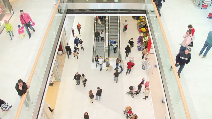 Slightly defocused crowd of walking people in the newly opened shopping mall