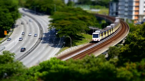 Aerial view - cars and light rail train miniature tilt shift lens effect time lapse.