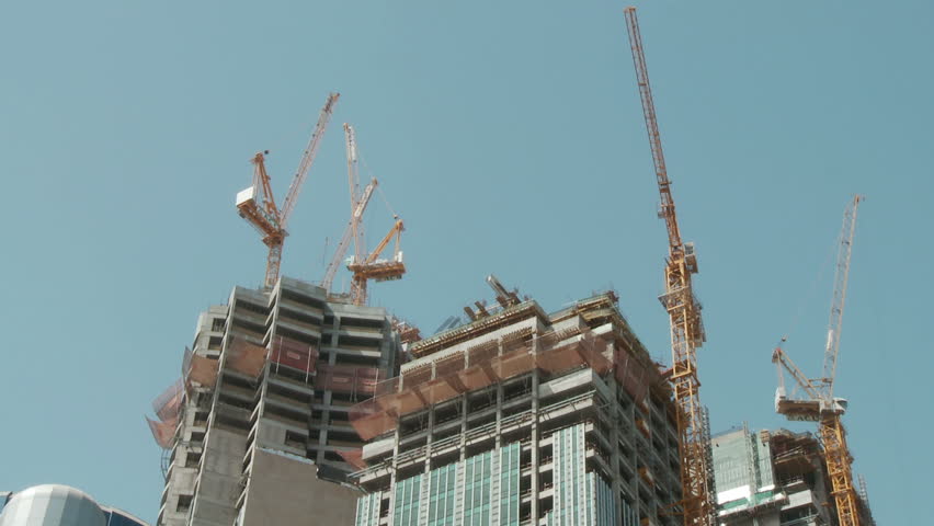 Overhead cranes working on a new high rise development.  Time Lapse