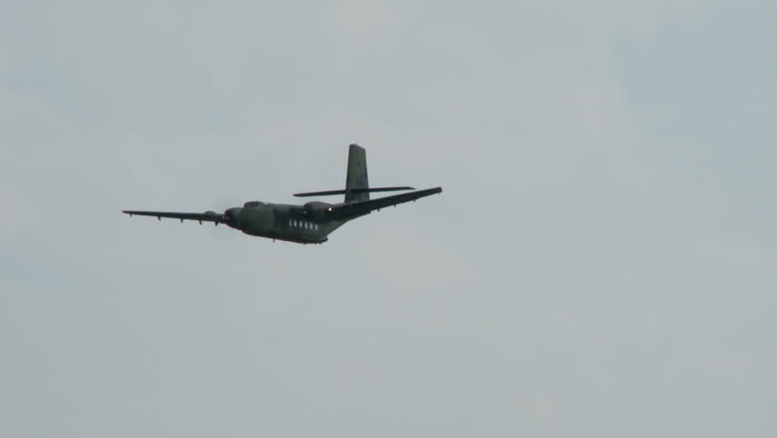 A caribou military cargo aircraft makes a banking left turn