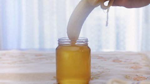 A partially peeled banana gets plunged in a jar of yellow honey. Visual metaphor for a certain type of sexual intercourse: use it when you must visually show but you can't put the real thing.