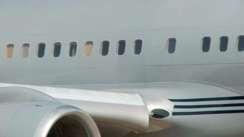 Close up of the windows of a Boeing 757 as it taxis to the runway