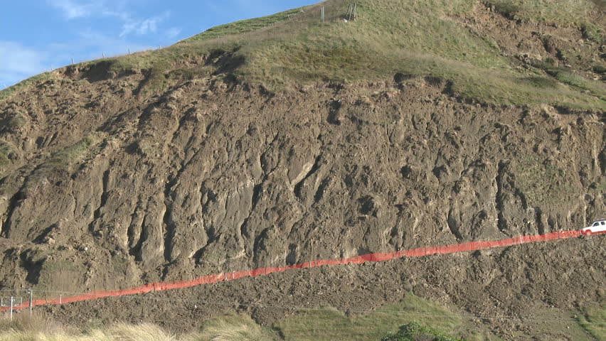 Hillside and road scarred by recent heavy rains and resulting landslides