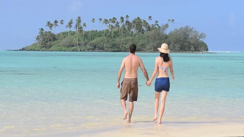 Attractive young happy couple on vacation having fun on Muri beach lagoon in Rarotonga, Cook Islands. Real people. Copy space