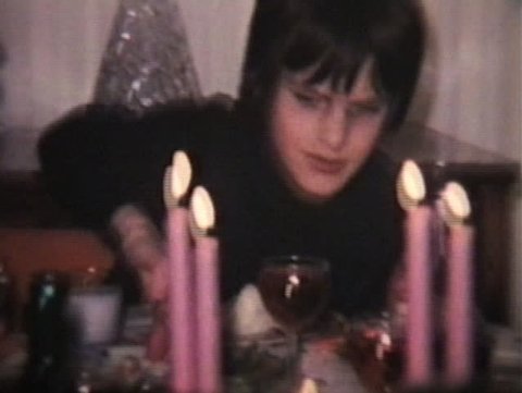 Two brothers making crazy faces at the camera at a family dinner. (1974 - Vintage 8mm film footage) Stock Video