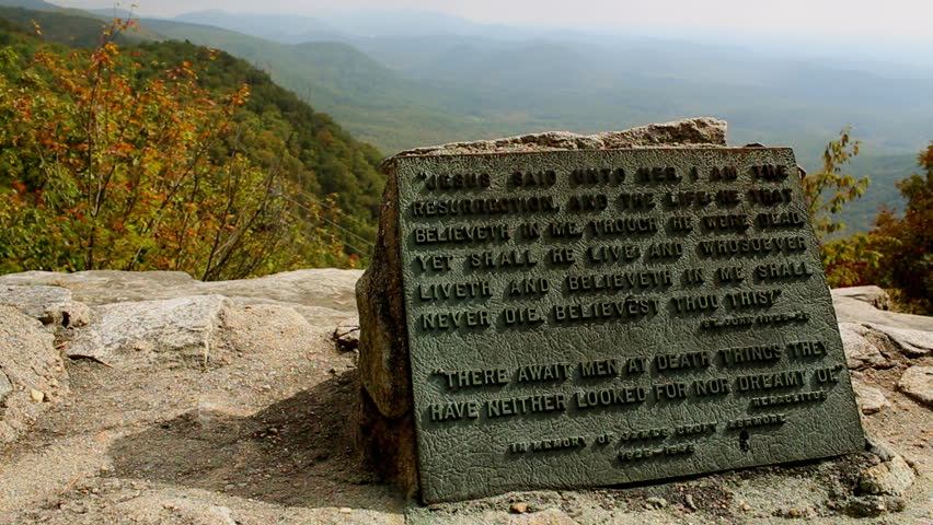 Bible verse on a stone tablet on a mountain top