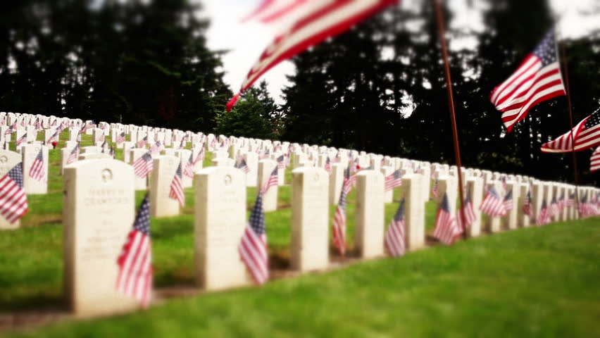 Tracking military cemetery, flowers and flags on tombstones