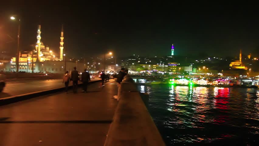 Night on the bridge. Eminonu region looking to Yeni Mosque and Beyazit Tower in