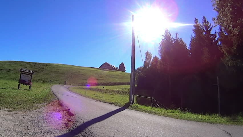 Woman cycling on a rural road  