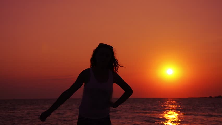 silhouette of teen exercising in sunset part II of II
