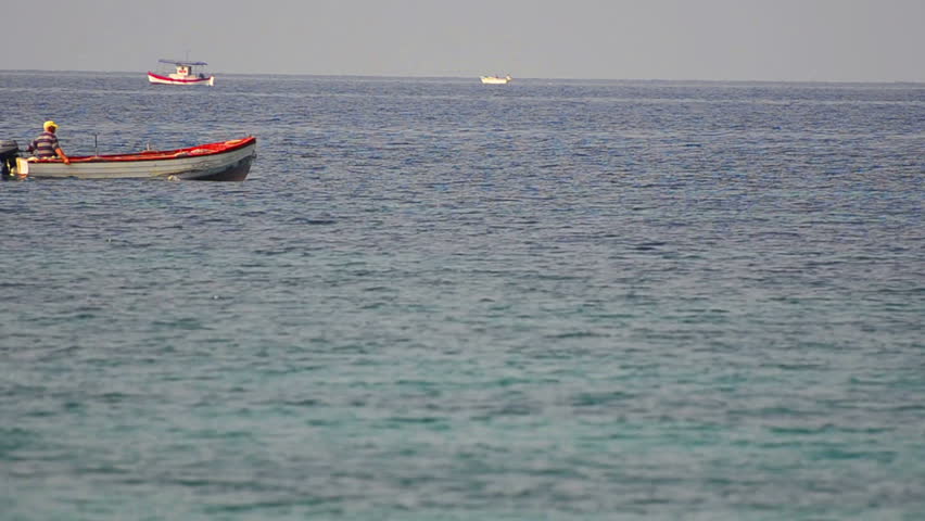 Ocean Blue Fisherman - Stock Video. A fishing boat and a fisherman on a a