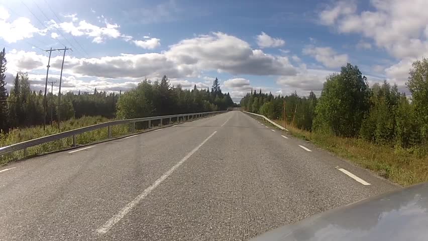 footage of a onboard camera, driving in a forest, sound included