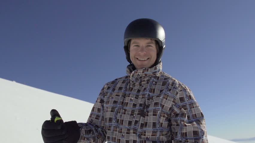 Slow Motion Of Male Skier With Thumb Up At Camera. He Sets Off To Skiing. 