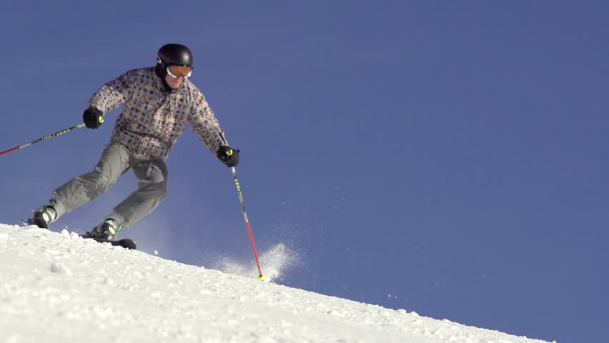 Slow Motion Of Skier Carving Down Fast And Snow Drifting. Focus Shifts. 