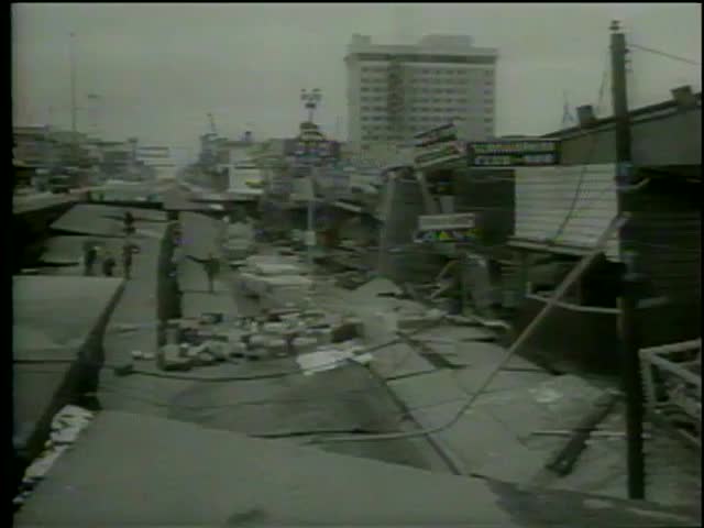 Earthquake damage on Fourth Avenue, Anchorage, Prince William Sound region, Alaska circa 1964. People salvage belongings from stores-MGM PICTURES, UNIVERSAL-INTERNATIONAL NEWSREEL, USA, filmed in 1964