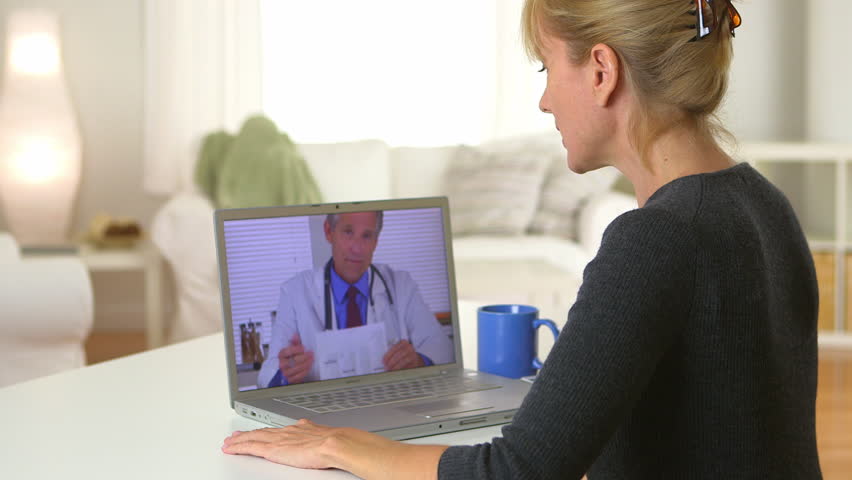 Mature woman having video chat with doctor on laptop Royalty-Free Stock Footage #5014034