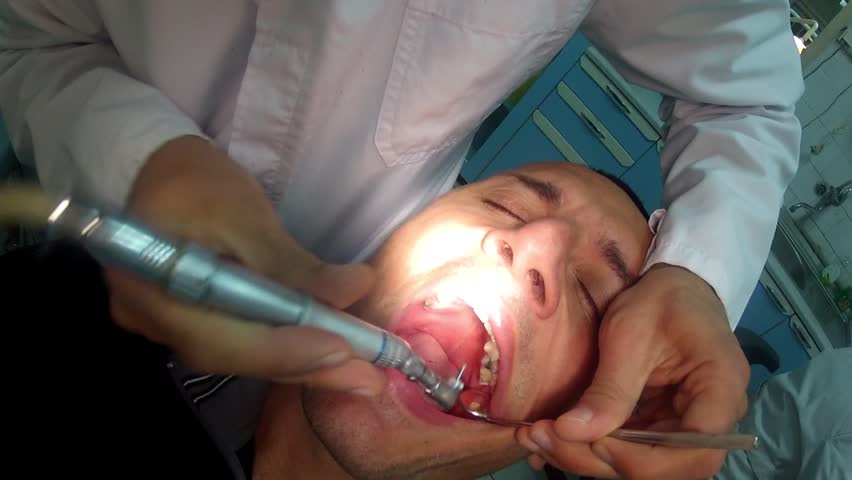 dentist is drilling tooth at stomathology ordination