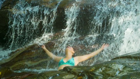 Video 1920x1080 - A woman enjoys bathing in a waterfall. Thailand. Phuket