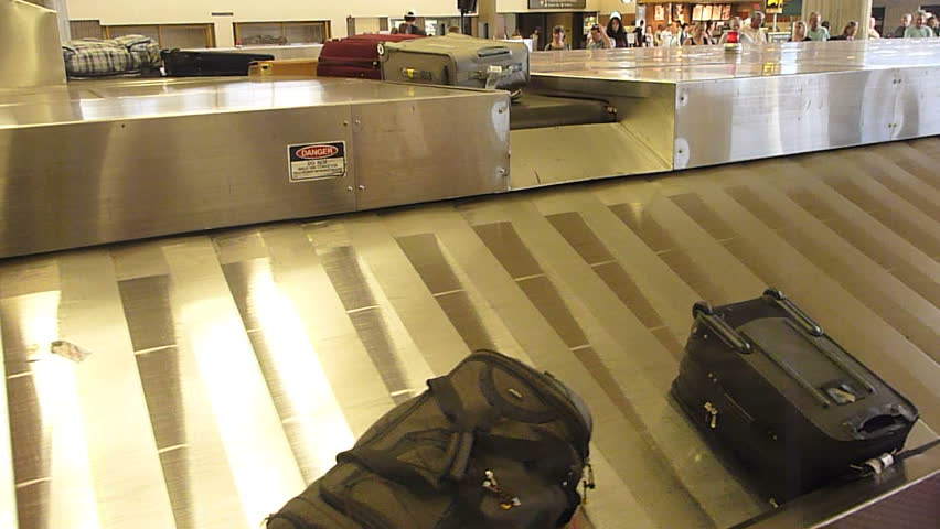 Interior Maui Hawaii Airport baggage claim with luggage spinning around conveyor. Royalty-Free Stock Footage #5021198