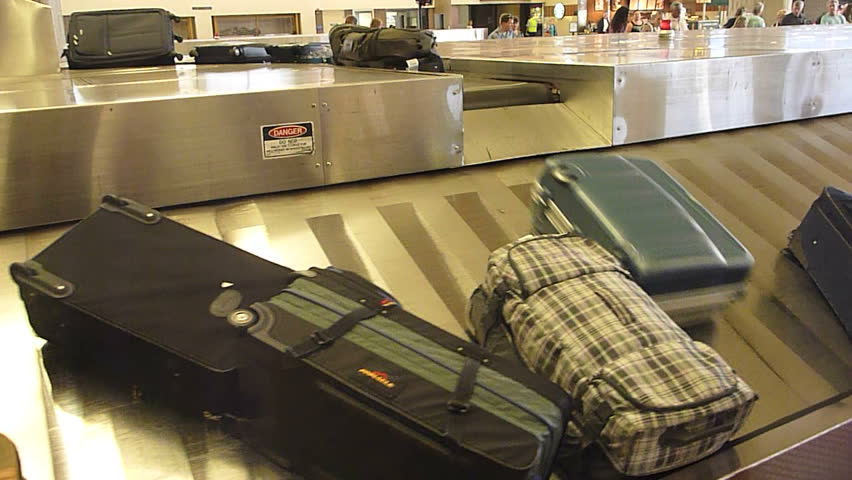 Interior Maui Hawaii Airport baggage claim with luggage spinning around