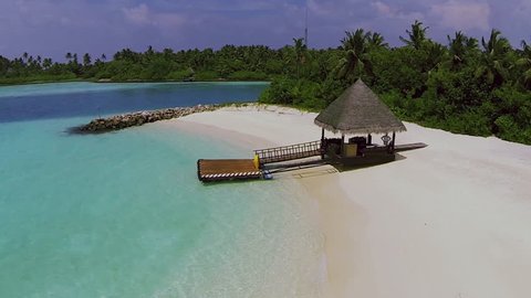 Maldives beach panorama with the house. aerial video