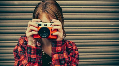 Teenage hipster woman having fun taking pictures with old camera in vintage color correction Stock Video