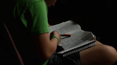 Scanning Bible at church, reading (young youth kid)