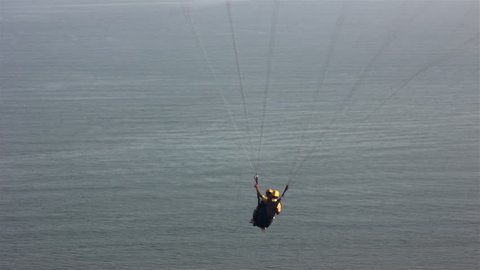 People practicing paraglider in the Santos ctiy