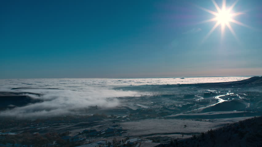 Waves of fog, moving like waves in the ocean, over Denver, Colorado. HD 1080p