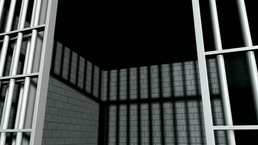 A static camera closeup of the door slamming shut a  brick jail cell with iron bars Royalty-Free Stock Footage #5027321