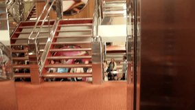 Elevator closing and people waiting near the stairs for their turn to ride the elevator instead of using the stairs.