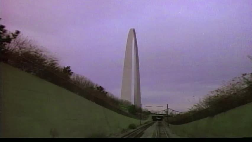 Tracking shot right to left of St. Louis Arch, approaching tunnel into and out the other side