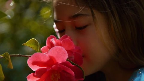 Adorable Little Girl Surprised By The Smell of A Flower
