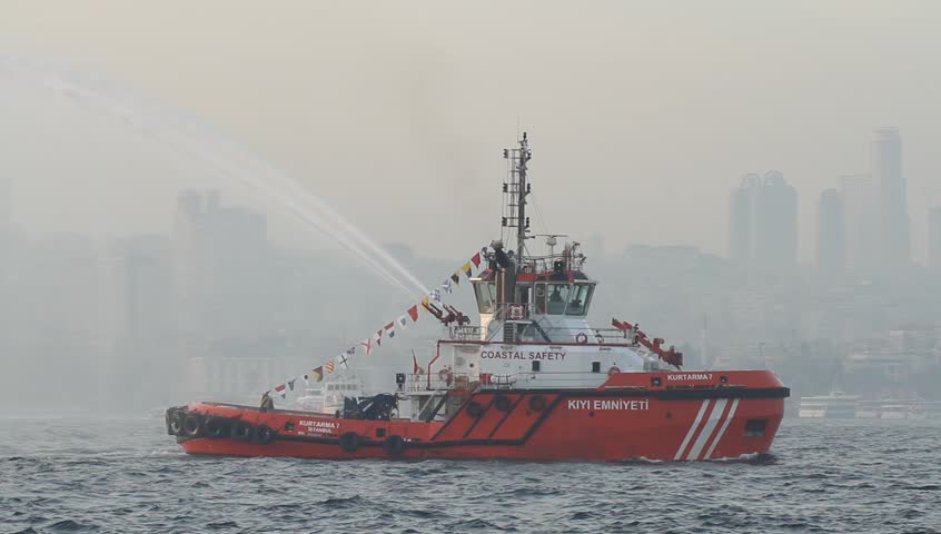 ISTANBUL - OCT 29: Tugboat KIYI EMNIYETI sprays arches of water in celebration