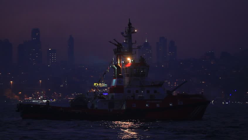 Tugboat waiting to be docked in the darkness of the night.