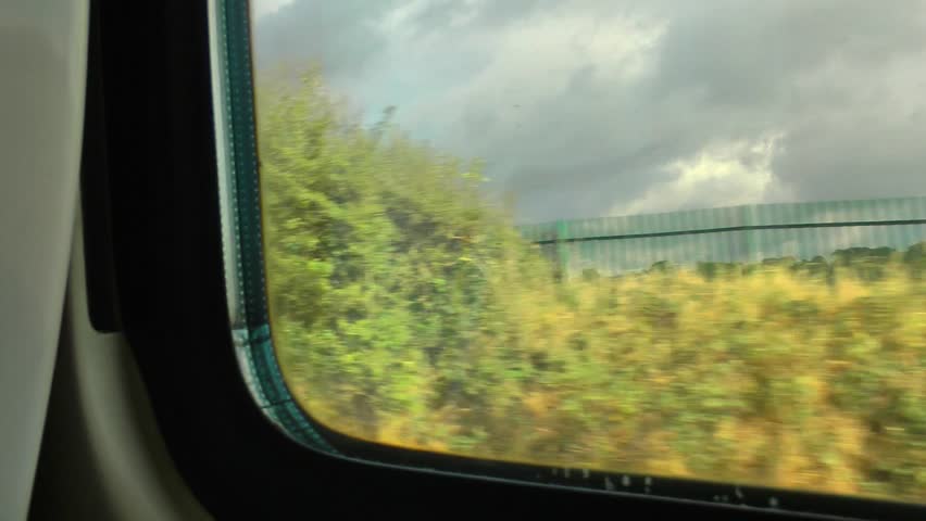 View from a train window passing through countryside
