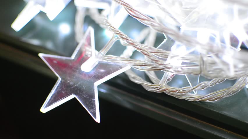 Illuminated souvenir light with star on black background, christmas tree