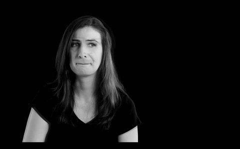 Portrait of young woman in a dark emotional moment, black and white footage,
black background