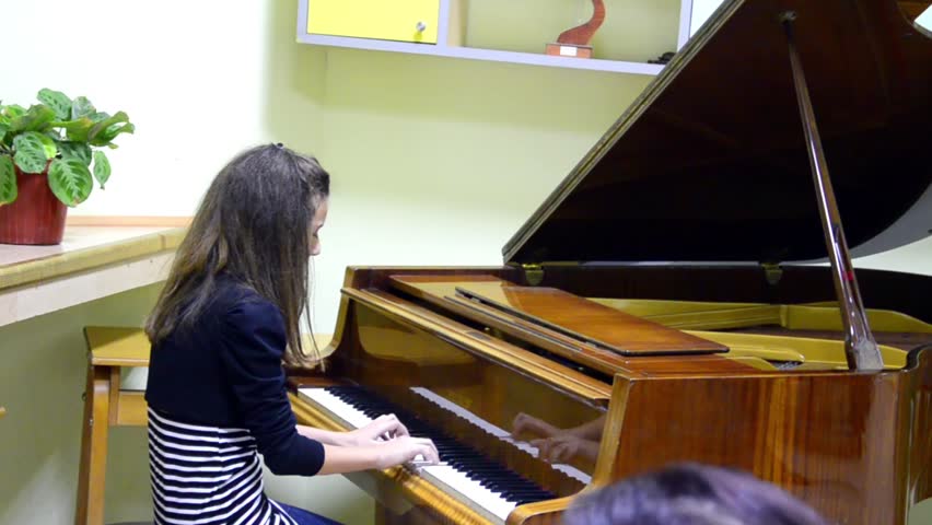 playing piano - Stock Video. Young girl playing a piano
