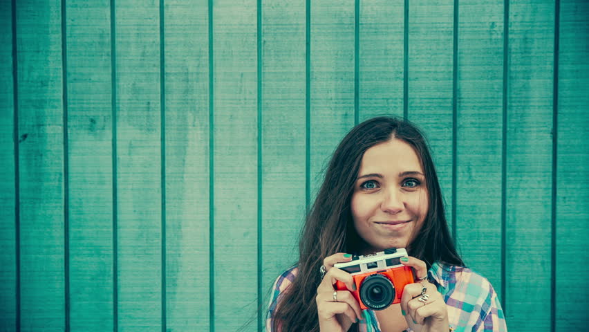 Woman with vintage Camera in front copy space