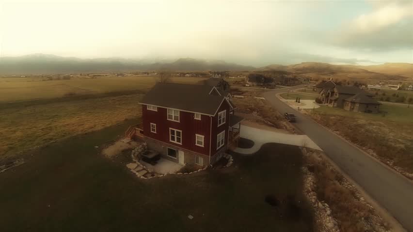 An aerial shot of a house in the rural countryside
