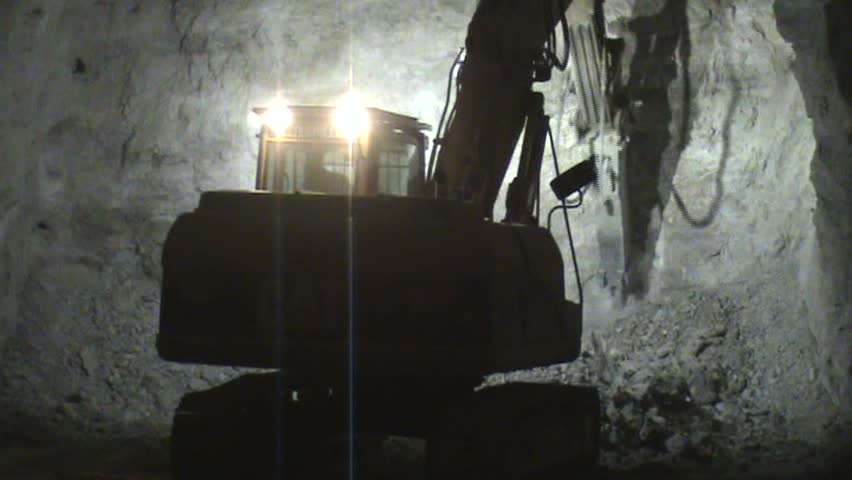 Loader loading a truck in a dark mine