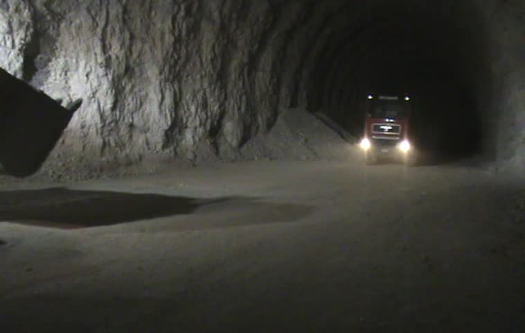 Loader loading a truck in a dark mine