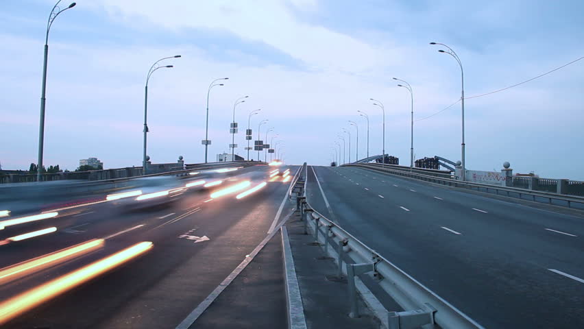 Timelapse of highway road junction, city vehicles pass lights on