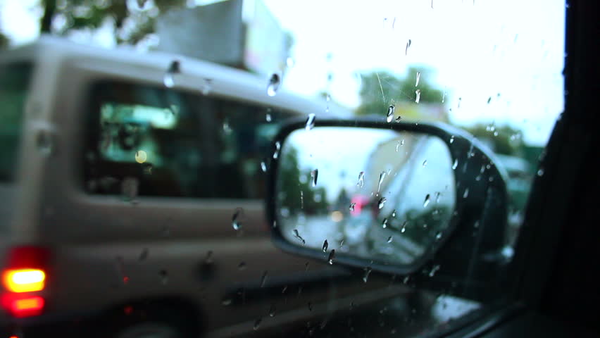Rainy day inside car view wet road drops on window
