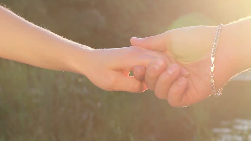 Love, friendship sign, man and women holding hands together