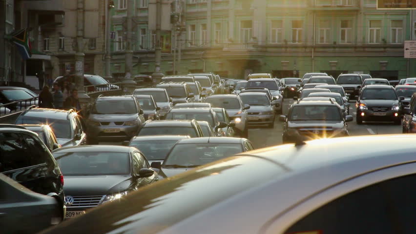 City cars vehicles lined traffic jam, dusk sun rays, movement Royalty-Free Stock Footage #5060426