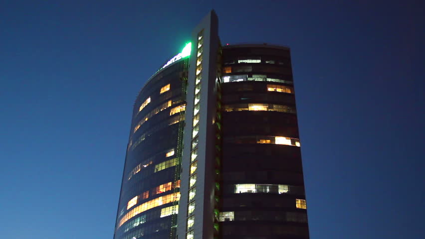 Night business center timelapse, lights turn on off offices work